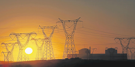 A view of the setting sun through the pylons of the Koeberg nuclear power station near Cape Town.