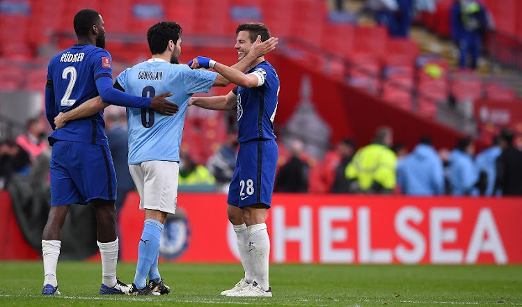 Ilkay Gundogan of Manchester City congratulates Antonio Ruediger of Chelsea and Cesar Azpilicueta of Chelsea following Chelsea's victory in the Semi Final of the Emirates FA Cup match between Manchester City and Chelsea FC at Wembley Stadium on April 17, 2021 in London, England.
