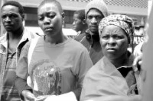 FIGHTING BACK: Desperation is written on the faces of these Utrecht residents as they waited outside the labour court in Durban yesterday after their case was postponed. Pic. Makgotso Gulube. 03/12/07. © Sowetan.
