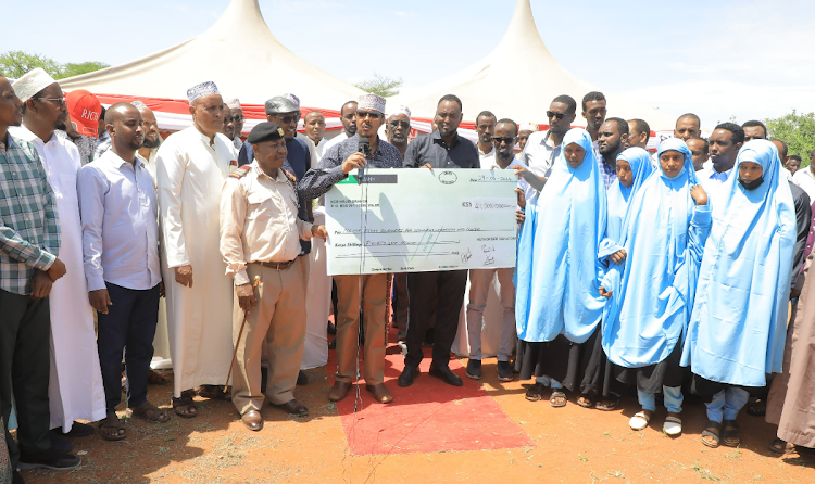 Eldas MP Adan Keynan poses with some of the beneficiaries of Sh41 million bursary for secondary school, university and college students in the constituency on April 29, 2024.