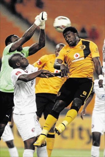 CLOSE SHAVE: Chiefs player Kingston Nkhatha fights for the ball with Swallows keeper Greg Etafia and Tsietsi Mahoa during their PSL match at FNB Stadium last night PHOTO: ANTONIO MUCHAVE