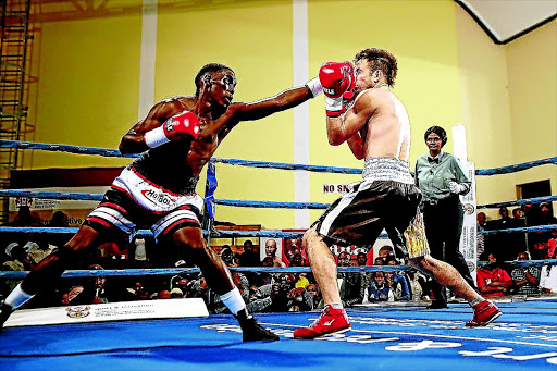 Xolisani Ndongeni jabs Miguel Escalada in their lightweight clash in this file picture. photo: MARK ANDREWS/ Daily Dispatch