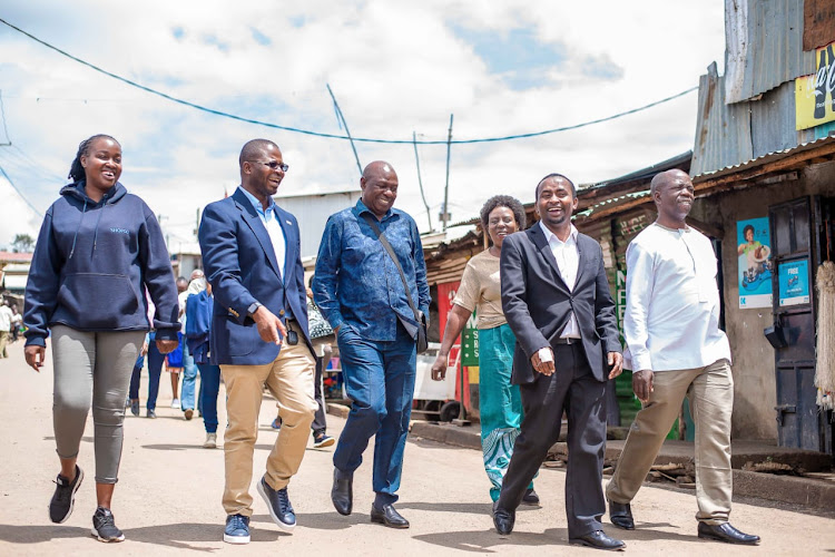 A section of Ugandan MPs led by Hon Charles Bakkabulindi (third from left) and SHOFCO staff led by Boniface Gatobu Kinoti (second from right) in the streets of Kibera on Tuesday, April 23, 2024.