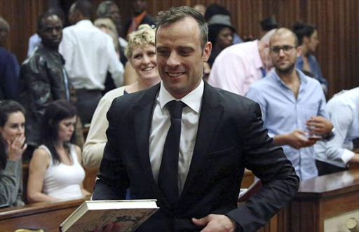 Oscar Pistorius reacts after he was granted bail as he leaves the North Gauteng High Court in Pretoria, South Africa after his bail hearing Picture: SIPHIWE SIBEKO