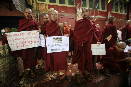 Myanmar Buddhist monks hold signs as they stage a demonstration near the Bangladesh embassy denouncing recent Muslim mob attacks on Buddhist temples in neighbouring Bangladesh, in Yangon on October 8, 2012. The violence in Bangladesh began on September 29 in the southeast of the country and spread to several towns and villages after claims that a young Buddhist man had posted photographs defaming the Koran onto social network website Facebook.