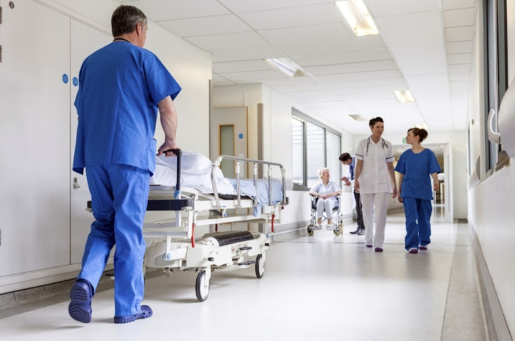 Hospital bed, nurse and doctor.