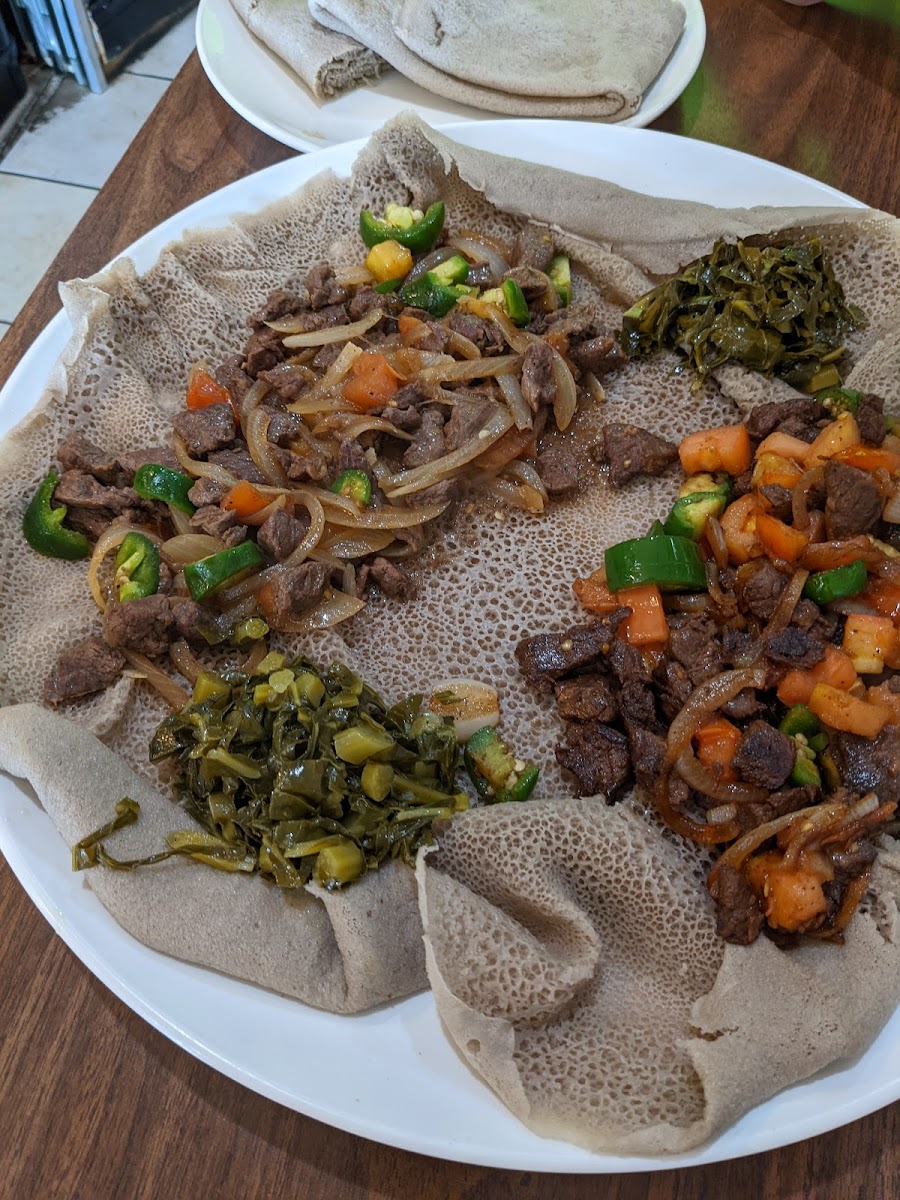 Beef tibs served on injera