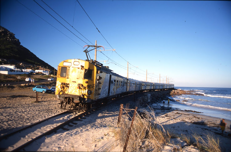 A file photo shows a Simon's Town-bound commuter train on the single-track section of the line at Clovelly. Trains between Fish Hoek and Simon's Town were suspended for months while repairs were carried out on overhead power masts and station platforms.