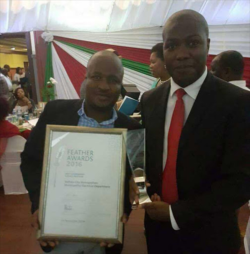 BRIGHT SPARKS: Buffalo City Metro portfolio head for infrastructure and engineering department Ncedo Kumbaca, right, with the department’s acting head Luyanda Mbula display their prestigious Feather award Picture: ZWANGA MUKHUTHU