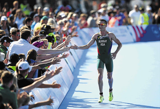 HAND IT TO HIM: Richard Murray of South Africa wins bronze in the men's triathlon at Strathclyde Country Park on day one of the 2014 Commonwealth Games in Glasgow, Scotland, yesterday