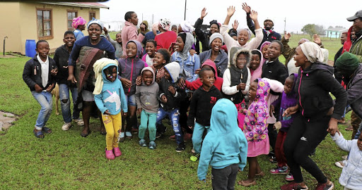 Young and old at Sidwadweni in Tsolo toast Zozibini Tunzi's Miss Universe 2019 victory yesterday. /LULAMILE FENI