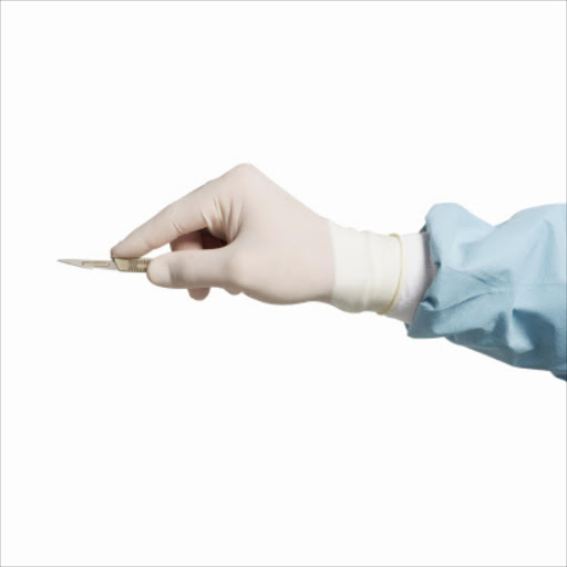 Surgeon's hand holding scalpel. File photo.