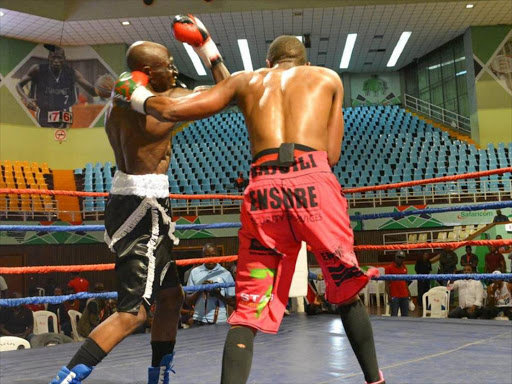 Kenya’s Michael Nyawade (L) against David Rajwili of South Africa during their Mac Series Professional Boxing Bonaza at Safaricom Indoor Arena . /COURTESY