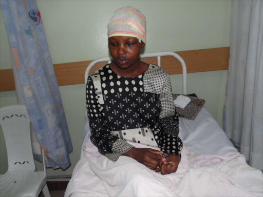 SILENT VICTIM: Justa Kawira on her hospital bed at Lang’ata hospital. She was battered by her husband at their home in Lang’ata estate and was rushed to the hospital by neighbours, unconscious.