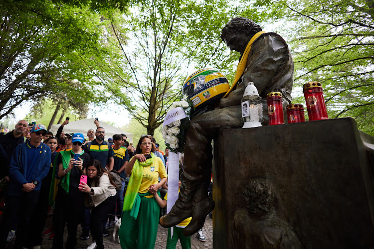 People visit the monument dedicated to Ayrton Senna during an event to commemorate the 30th anniversary of Ayrton Senna’s death at Autodromo Enzo e Dino Ferrari on May 1 2024 in Imola, Italy. Picture: GETTY IMAGES/EMMANUELE CIANCAGLINI.