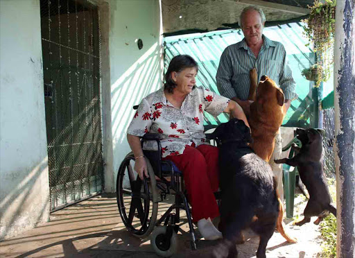 HORRIFIED: Miekie and Errol Petzer with Caesar, Lady and Blackie at their Christmas Rock smallholding. Their Siberian Husky cross Misty was found hanging on the fencepost last Friday Picture: ALAN EASON