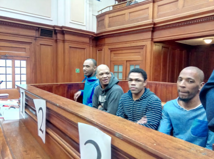 The men accused of raping and murdering Hannah Cornelius put hands over their gaping mouths as the meaning of their tattoos was described in the high court in Cape Town.