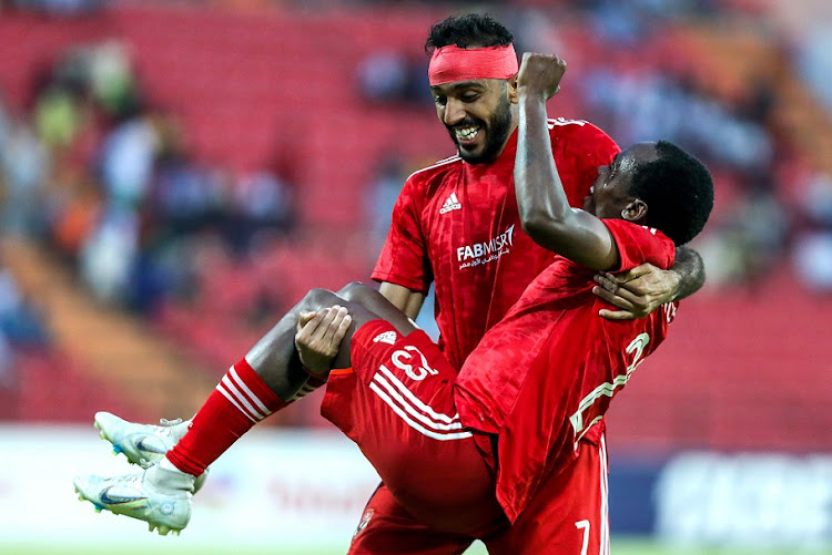 Mahmoud Kahraba and Percy Tau of Al Ahly celebrate a goal during the Caf Champions League match against Coton Sport at Roumdé Adjia Stadium in Garoua, Cameroon on March 17 2023.