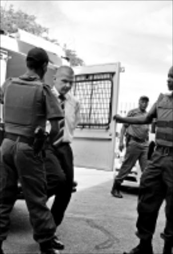 TEENAGE KILLER: Johan Nel arriving at the Mafikeng high court in Mmabatho under heavy police guard yesterday. 18/11/2008. Pic. Nonhlanhla Kambule -Makgati. © Unknown