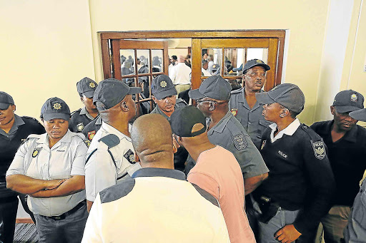 STAND- OFF: Samwu members in discussions with police at the King David Hotel in East London, where a council meeting was being held. Samwu members were trying to enter the meeting to demand information about funds used for Nelson Mandela’s funeral Picture: STEPHANIE LLOYD