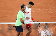 Novak Djokovic of Serbia salutes Rafael Nadal of Spain after his semi-final victory on day 13 of the French Open at Roland Garros in Paris on June 11, 2021. File photo