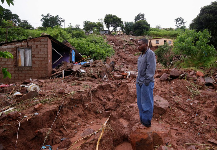 Jomba Phiri walks over where his house stood after heavy rains caused flood damage in KwaNdengezi, Durban, South Africa, April 12, 2022.
