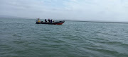 A SAPS rescue craft patrols Jozini Dam while searching for three missing fishermen.

