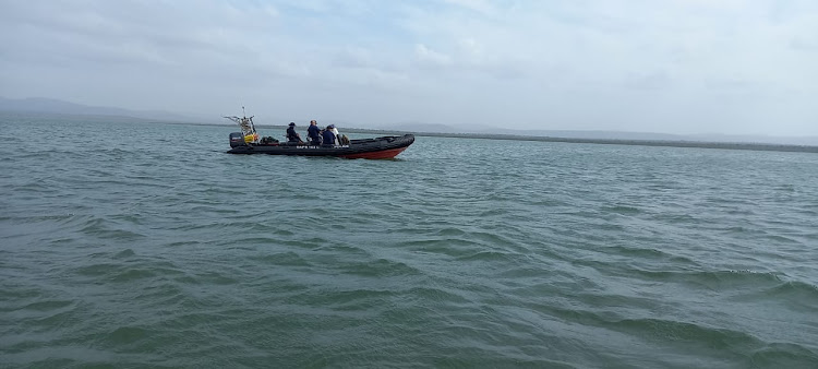 A SAPS rescue craft patrols Jozini Dam while searching for three missing fishermen.