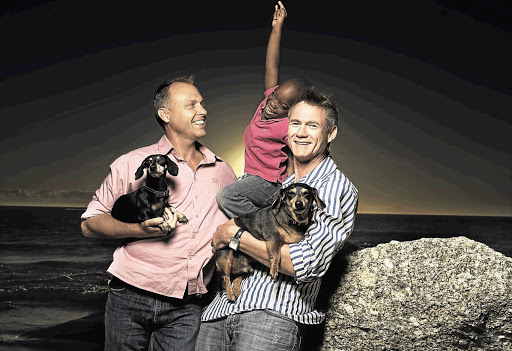 Anton Middleton and Jean Paul Krooneman at Camps Bay with their six-year-old adopted son Picture: ROB DURAND