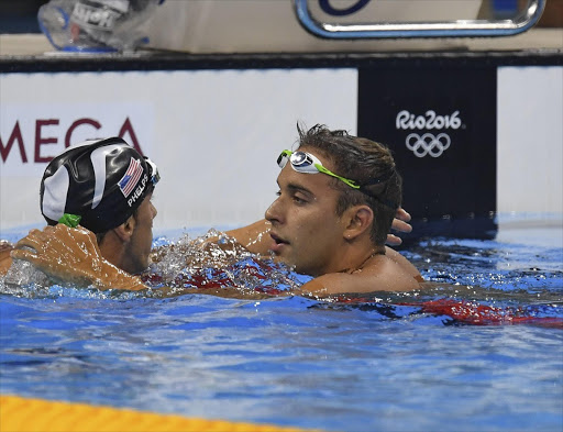 Michael Phelps of the USA and Chad le Clos of South Africa embrace after Phelps won the final of the mens 200m butterfly during day 4 of the Swimming at Olympic Aquatics Stadium on August 09, 2016 in Rio de Janeiro, Brazil. Picture Credit by Gallo Images/Roger Sedres