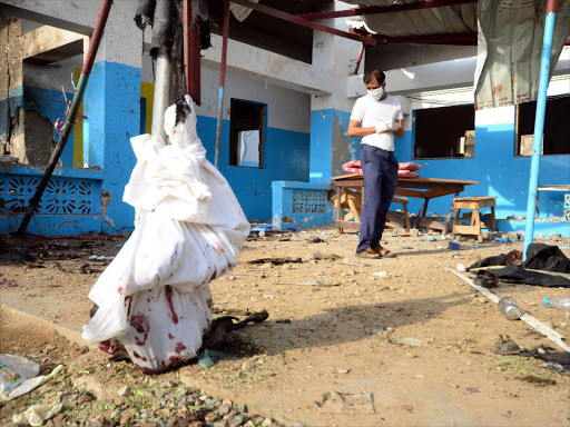 A worker looks for human remains at the yard of a hospital operated by Medecins Sans Frontieres after it was hit by a Saudi-led coalition air strike in the Abs district of Hajja province, Yemen August 16, 2016 /REUTERS