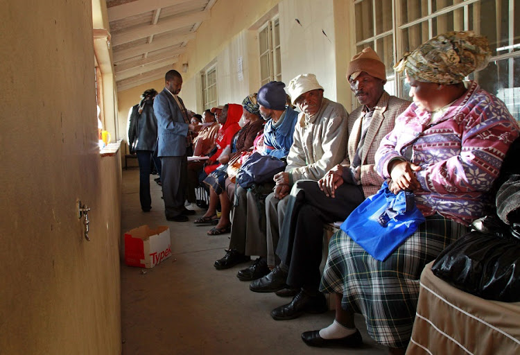 VULNERABLE: Grant recipients wait for payouts at a South African Social Security Agency office. Picture: SUNDAY TIMES
