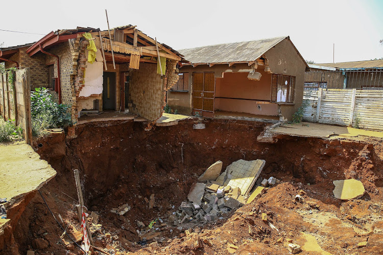 A house in Merafong has swallowed by a sinkhole, a problem which has plagued the area for years. Image:: SIMPHIWE NKWALI