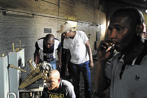 POWER TO THE PEOPLE: Blyvoor community members try to reconnect the power supply at an electricity substation that is believed to have been raided by cable thieves yesterday