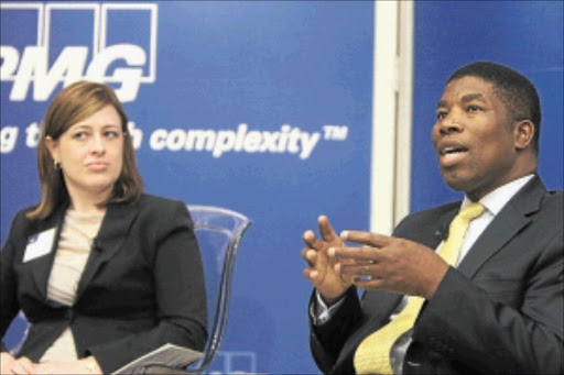 MAKING A POINT: Lulu Kruger and Chamber of Mines CEO Bheki Sibiya during the business breakfast meeting at KPMG in Johannesburg. PHOTO : ANTONIO MUCHAVE .