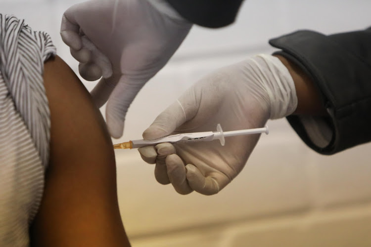 A patient receives a Covid-19 vaccination at an undisclosed hospital in Johannesburg on Wednesday. The patient was one of the first to take part in an international vaccine trial.