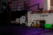 Laura Emiko Soltis, 37, holds her hands by a makeshift memorial outside of Gold Spa following the deadly shootings in Atlanta, Georgia, US March 17, 2021. 