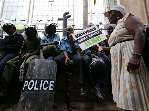 A CORD Coalition supporter have a word with police during their anti IEBC protest outside the IEBC office at Anniversary Towers on May 9, 2016. Photo/Jack Owuor