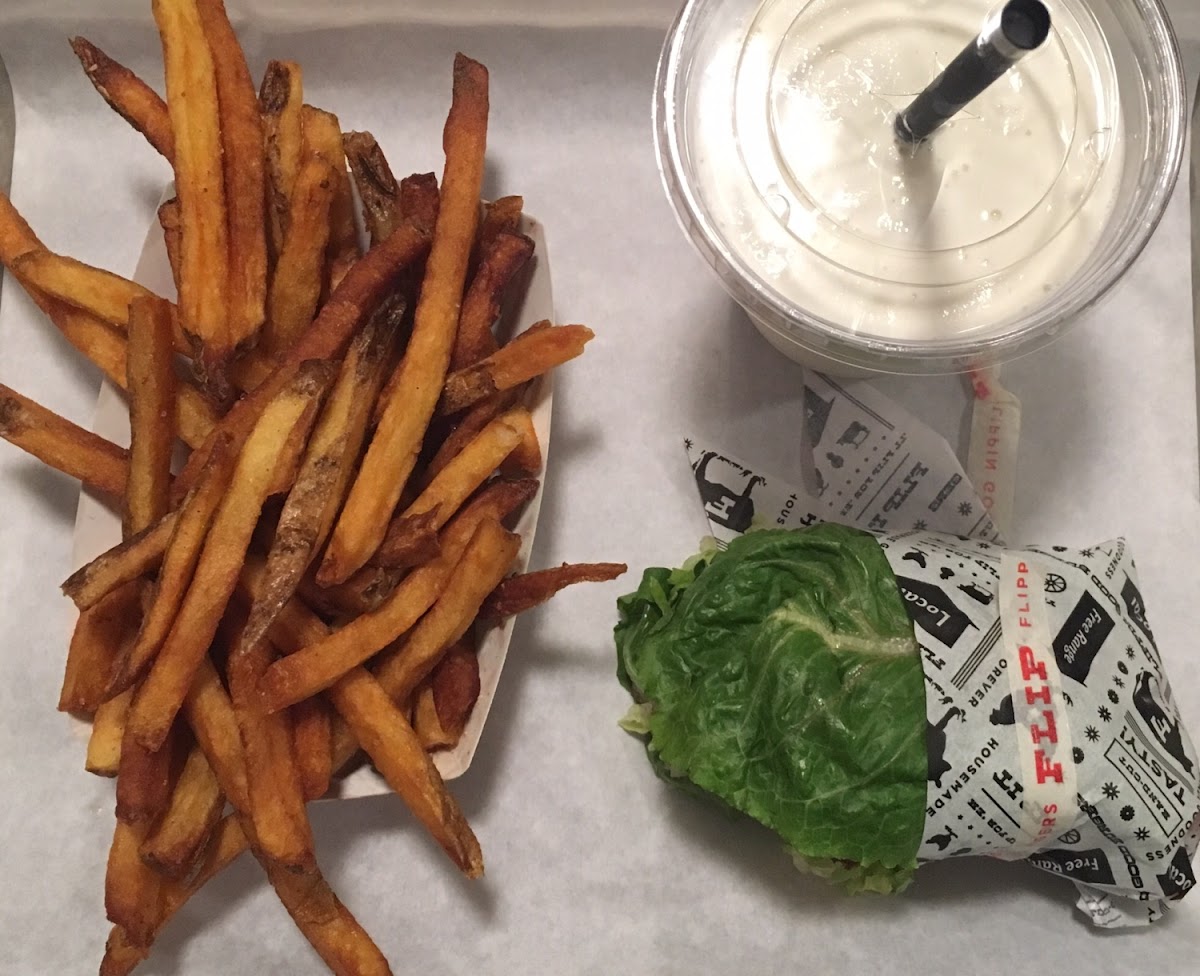 GF burger in lettuce wrap, fries, and vanilla milkshake.