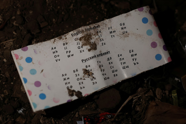 A piece of paper displaying the letters of the English and Russian Alphabets is seen discarded inside a former Russian trench, amid Russia's attack on Dovgalivka, in Dovgalivka, Ukraine, October 22, 2022.