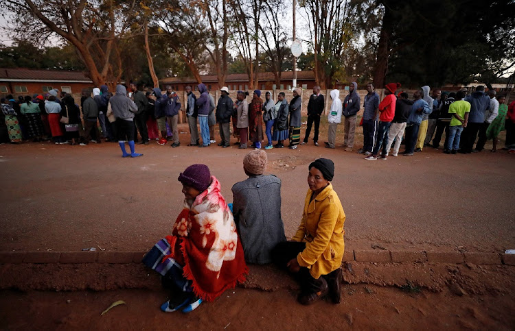 Zimbabwean voters queue to cast their ballots in the country's general elections in Harare, Zimbabwe, July 30, 2018.