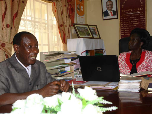 OLD FOOTAGE: Keveye Girls Secondary School Board of Management vice chairman Elias Onyango and principal Judith Ngome at the school on Monday. Onyango said detractors are trying to give the school a bad name.