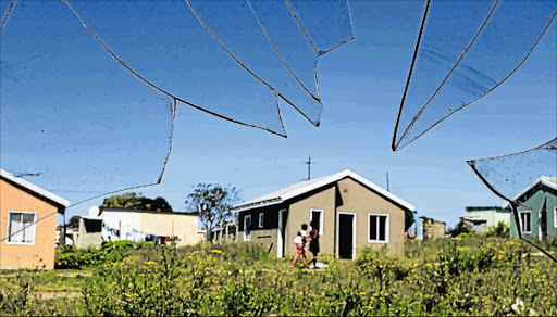 SHATTERED PROMISES: A view through a broken window of a vandalised and unoccupied house in Unit P on the outskirts of Mdantsane. There are 154 houses in the area that have been unoccupied since 2013 because the rightful owners could not be located Picture: ALAN EASON