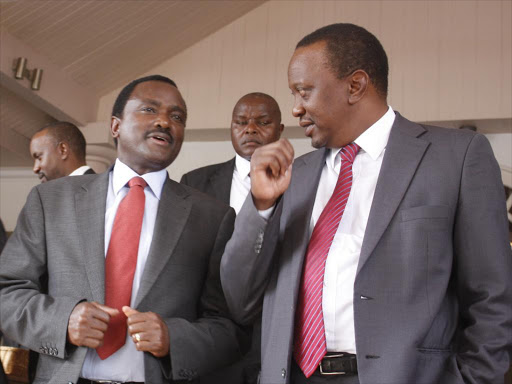 Wiper leader Kalonzo Musyoka greets President Uhuru Kenyatta during a service in Nairobi, 2013. /FILE