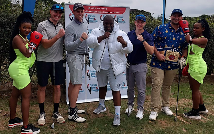 Boxing promoter Sandile Vilakazi in white jacket with golfers who are keen to be involved in boxing.