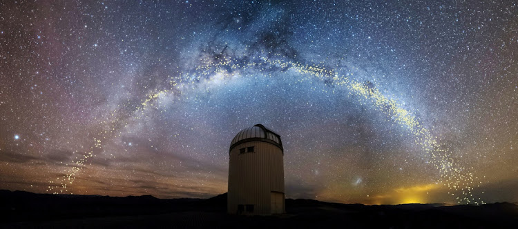 The warped shape of the stellar disk of the Milky Way galaxy, determined by mapping the distribution of young stars called Cepheids with distances set out in light years, is seen over the Warsaw University Telescope at Las Campanas Observatory in Chile, in an artist's rendition released August 1 2019. Picture: UNIVERSITY OF WARSAW/HANDOUT VIA REUTERS/JAN SKOWRON
