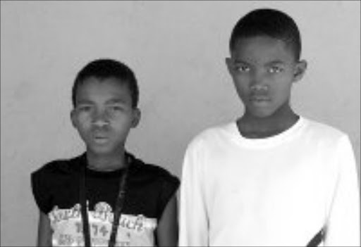 IN MOURNING: Mpho and Fana cannot stop crying for their friend who was run over by a car. Pic. Mohau Mofokeng. 06/09/2007. © Sowetan.