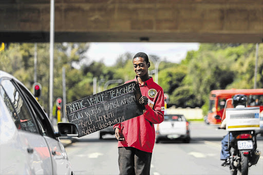 ROAD WORK: Moses Vilaphi, from Soweto, gives Zulu lessons at intersections in Johannesburg. He can make up to R200 a day and sleeps under a bridge near Empire Road