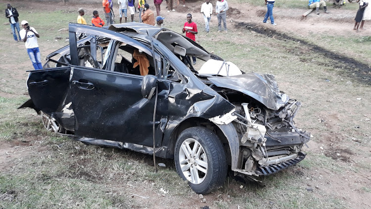 Members of the public view the wreck of a personal car that was hit by two trailers in Marula Naivasha along the Nairobi-Nakuru highway killing six members of the family.