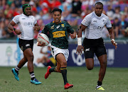 South Africa's Selvyn Davids runs to score a try against Fiji at the Hong Kong Sevens.